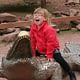 child riding crocodile statue at zoo
