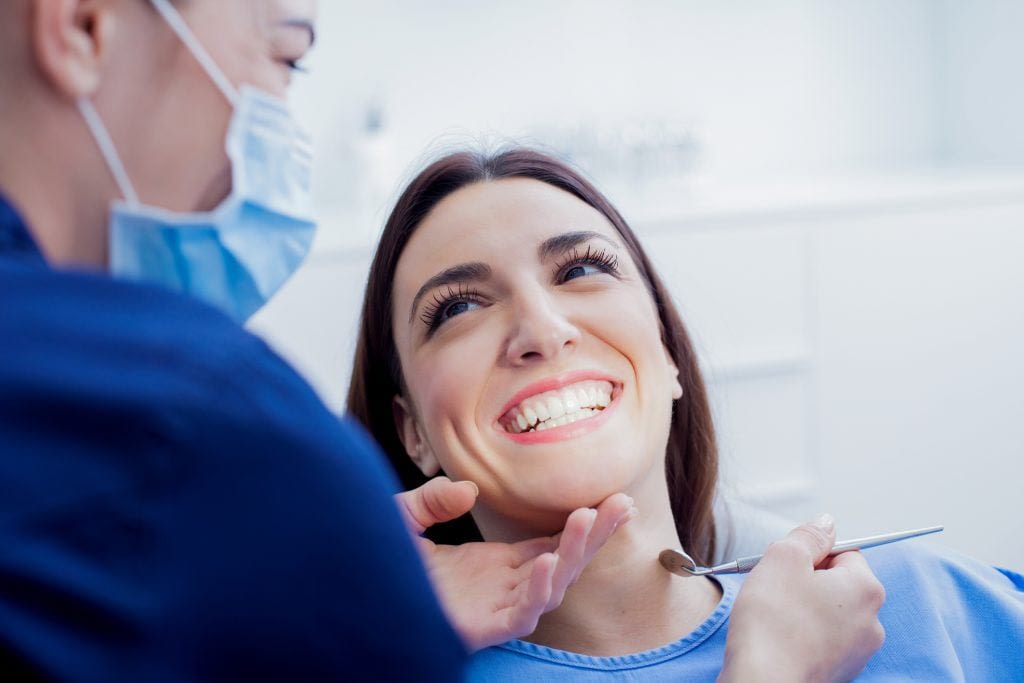 Women smiling at a dental exam