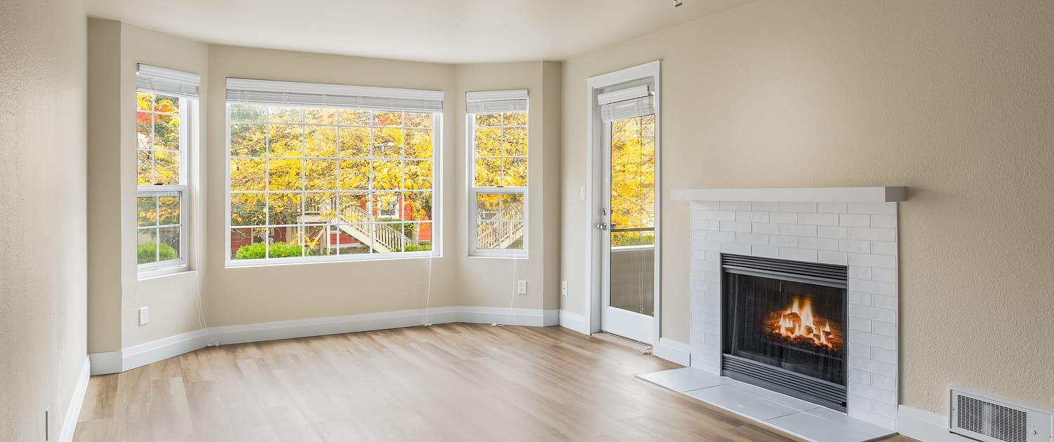 The gas fireplace and white tile surround inside a Haller Post apartment.